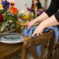 closeup shot woman wearing black shirt folding blue napkins table 85x85